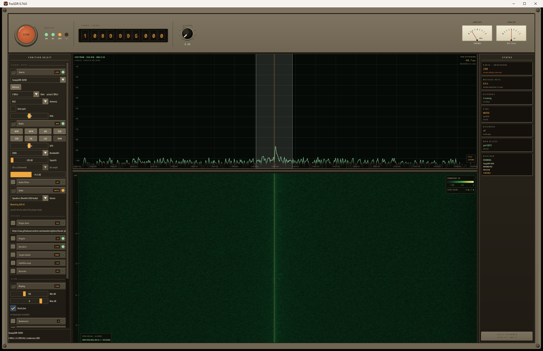 The FoxSDR console: an instrument panel with a round red stop button, nixie-style hertz readout, needle meters, a function-select rail, a green spectrum trace and a waterfall below it.